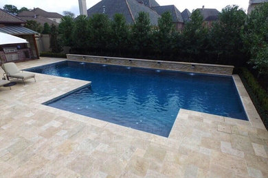 Large trendy backyard concrete paver and rectangular lap pool fountain photo in New Orleans