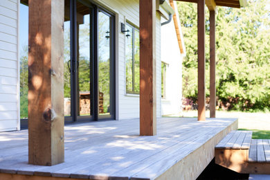 Inspiration for a country front porch remodel in Seattle with decking and a roof extension
