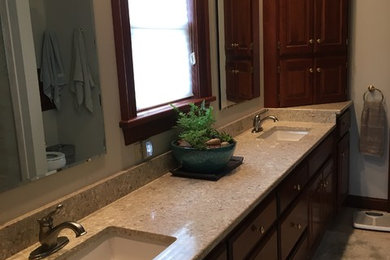 Mid-sized transitional master bathroom in Kansas City with raised-panel cabinets, medium wood cabinets, white walls, porcelain floors, an undermount sink, granite benchtops, beige floor and beige benchtops.
