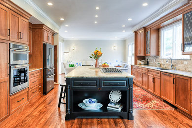 Design ideas for an expansive traditional galley eat-in kitchen in DC Metro with an undermount sink, recessed-panel cabinets, medium wood cabinets, quartzite benchtops, beige splashback, porcelain splashback, stainless steel appliances, medium hardwood floors, with island, brown floor and beige benchtop.