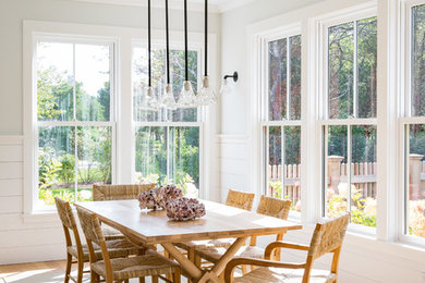 Inspiration for a mid-sized coastal medium tone wood floor and brown floor great room remodel in Boston with white walls and no fireplace