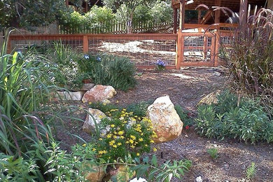 Photo of a large traditional partial sun backyard mulch landscaping in Austin.