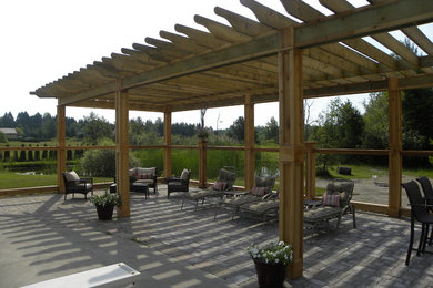 Patio - mid-sized rustic backyard brick patio idea in Toronto with a pergola