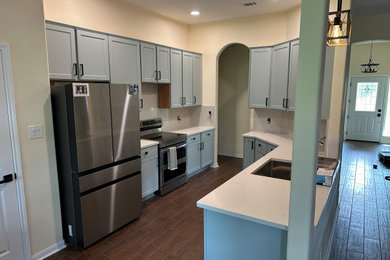 Enclosed kitchen - mid-sized contemporary enclosed kitchen idea in Austin with shaker cabinets and quartz countertops