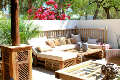 This is an example of a mid-sized eclectic courtyard patio in Phoenix with brick pavers.
