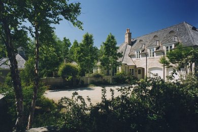 Elegant white two-story stucco exterior home photo in Charlotte