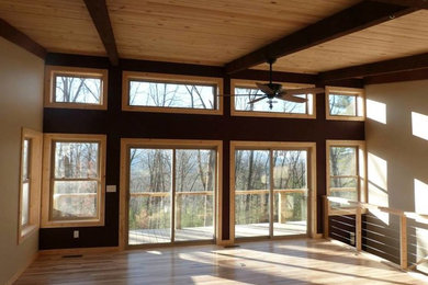 Inspiration for a large open concept light wood floor living room remodel in Charlotte with beige walls