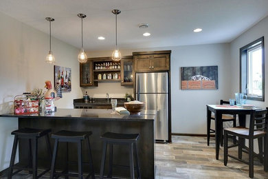 Inspiration for a transitional porcelain tile seated home bar remodel in Minneapolis with an undermount sink, recessed-panel cabinets, medium tone wood cabinets and granite countertops