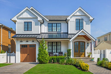 Cottage white two-story board and batten and clapboard exterior home photo in New York with a shingle roof and a gray roof