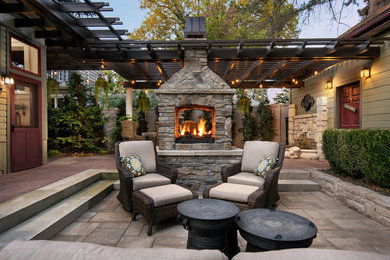 This is an example of a mid-sized traditional backyard patio in Boise with a fire feature, concrete pavers and a pergola.