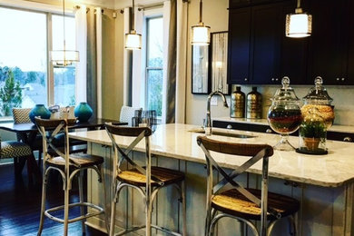 Example of a mid-sized minimalist l-shaped light wood floor and brown floor eat-in kitchen design in New York with a drop-in sink, flat-panel cabinets, brown cabinets, granite countertops, beige backsplash, stone tile backsplash, stainless steel appliances and an island