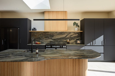 Photo of a large contemporary l-shaped kitchen/diner in London with an island.