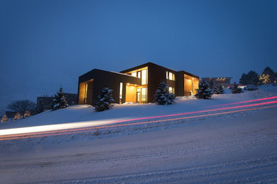Example of a trendy mixed siding flat roof design in Salt Lake City