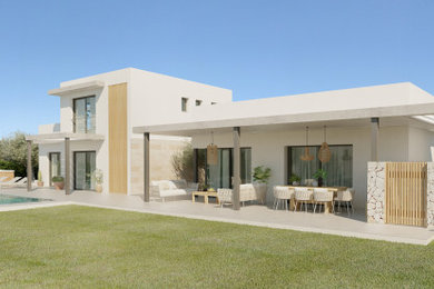 Photo of a large and white mediterranean two floor detached house in Other with concrete fibreboard cladding, a flat roof, a mixed material roof and a white roof.