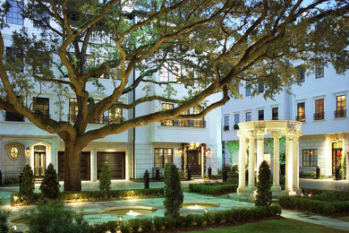 Large transitional white three-story stucco townhouse exterior idea in Houston