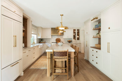 Example of a transitional kitchen design in Philadelphia with shaker cabinets and an island