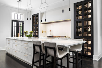 Example of a large minimalist eat-in kitchen design in Other with glass-front cabinets, marble countertops, white backsplash, an island and white countertops