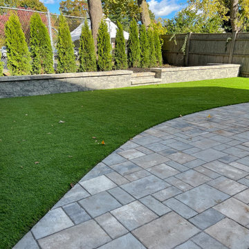 Privacy plantings, patio, and synthetic turf
