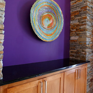 This is an example of a medium sized mediterranean open plan living room in Dallas with multi-coloured walls, light hardwood flooring, a standard fireplace and a brick fireplace surround.