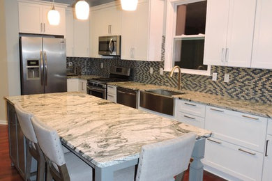 Kitchen - mid-sized contemporary l-shaped dark wood floor and brown floor kitchen idea in Baltimore with a farmhouse sink, shaker cabinets, white cabinets, granite countertops, multicolored backsplash, mosaic tile backsplash, stainless steel appliances and an island