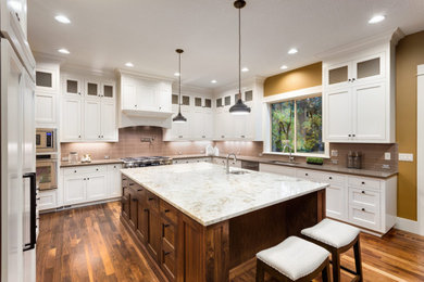 Eat-in kitchen - large u-shaped laminate floor eat-in kitchen idea in New Orleans with a single-bowl sink, raised-panel cabinets, white cabinets, marble countertops, mosaic tile backsplash, black appliances, an island and multicolored countertops