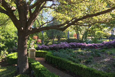 This is an example of a huge traditional partial sun backyard brick landscaping in Dallas.
