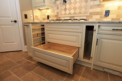 Example of a mid-sized cottage chic u-shaped porcelain tile eat-in kitchen design in Atlanta with an undermount sink, raised-panel cabinets, white cabinets, granite countertops, beige backsplash, stone tile backsplash, stainless steel appliances and an island