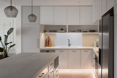 Inspiration for a large contemporary l-shaped open plan kitchen in Sydney with a double-bowl sink, shaker cabinets, grey cabinets, engineered stone countertops, engineered quartz splashback, stainless steel appliances and an island.