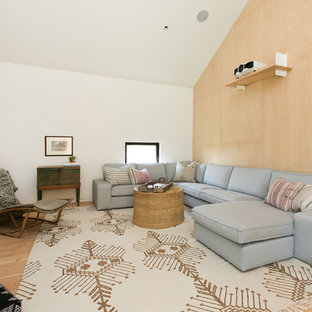 Cottage medium tone wood floor and brown floor home theater photo in Los Angeles with white walls and a projector screen