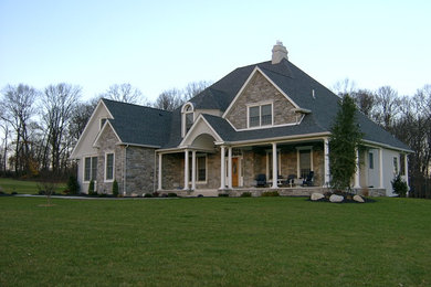 Inspiration for a large craftsman beige two-story mixed siding exterior home remodel in Philadelphia with a gambrel roof