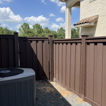 Dark Brown Composite Trex Fence and Black Iron Fence