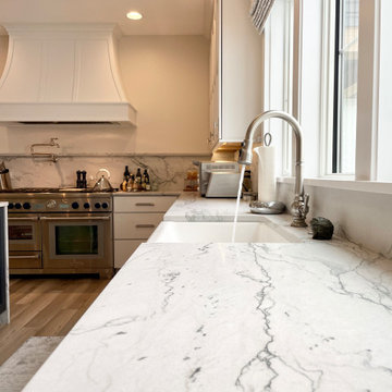 Kitchen Design with White and Blue Cabinets and Quartzite Natural Stone Counters
