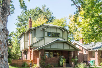 Inspiration for a mid-sized arts and crafts two-storey green house exterior in Denver with concrete fiberboard siding, a clipped gable roof and a shingle roof.