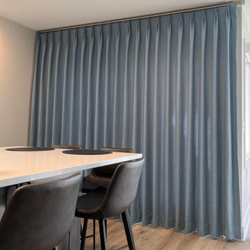 Blue pinch-pleated drapery