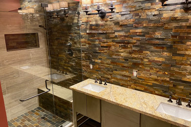 Example of a mountain style multicolored tile and slate tile double-sink bathroom design in Miami with flat-panel cabinets, light wood cabinets, an undermount sink, beige countertops and a freestanding vanity