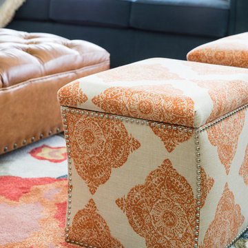 Layered Living Room Textures with Tufted Ottoman and Vibrant Rug