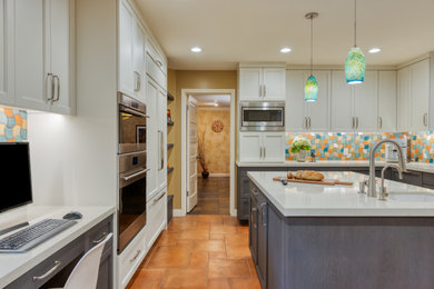 Kitchen - transitional u-shaped porcelain tile kitchen idea in San Francisco with quartz countertops, multicolored backsplash, mosaic tile backsplash, an island and beige countertops
