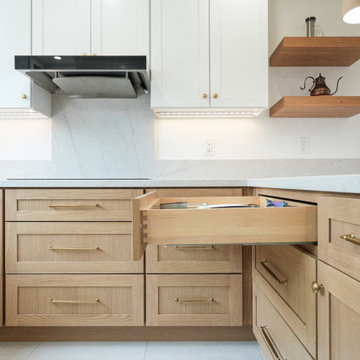 Modern White and Natural Oak Kitchen with Brass Hardware and Quartz Backsplash