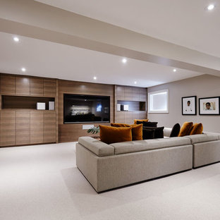 Large trendy enclosed carpeted and white floor home theater photo in Montreal with gray walls and a media wall