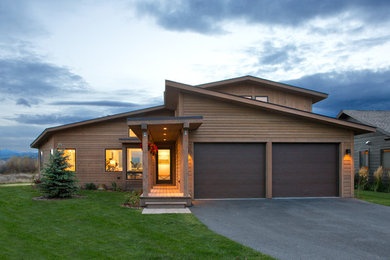 Inspiration for a transitional two-storey brown exterior in Other with wood siding.