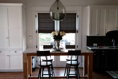 Mid-sized elegant dark wood floor kitchen photo in Charlotte with a double-bowl sink, shaker cabinets, white cabinets, black backsplash, ceramic backsplash, stainless steel appliances, an island and marble countertops