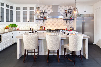 Inspiration for a large mediterranean u-shaped slate floor and gray floor kitchen remodel in Orange County with stainless steel appliances, quartz countertops, white cabinets, an island, multicolored backsplash, an undermount sink, beaded inset cabinets and cement tile backsplash