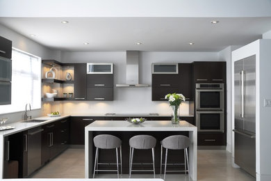 Open concept kitchen - large modern l-shaped ceramic tile open concept kitchen idea in Ottawa with an undermount sink, flat-panel cabinets, brown cabinets, quartzite countertops, stainless steel appliances and an island