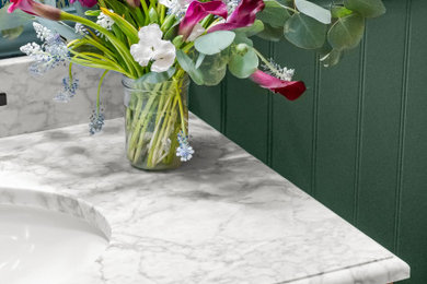 Example of a small transitional ceramic tile, multicolored floor and wallpaper powder room design in San Francisco with furniture-like cabinets, medium tone wood cabinets, a two-piece toilet, multicolored walls, an undermount sink, marble countertops, gray countertops and a freestanding vanity