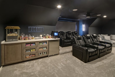 Example of a mid-sized transitional enclosed carpeted home theater design in Chicago with black walls and a wall-mounted tv