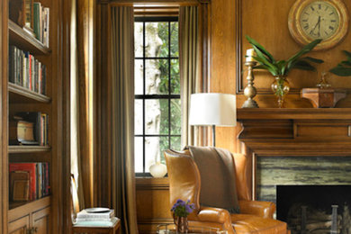 Freestanding desk dark wood floor study room photo in Cincinnati with brown walls