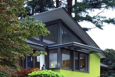 Mid-sized trendy green one-story stucco gable roof photo in Atlanta