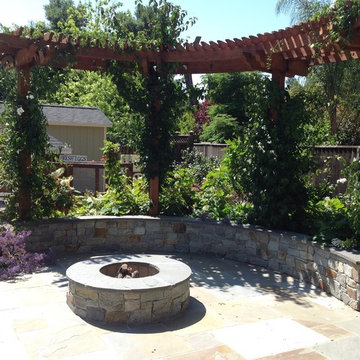 Pergola, fire pit and natural stone seat wall