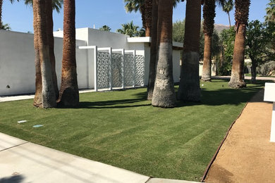 Example of a trendy white stucco exterior home design in Other