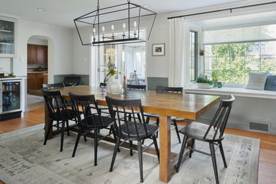 Inspiration for a large farmhouse medium tone wood floor, brown floor and wainscoting enclosed dining room remodel in Philadelphia with gray walls and no fireplace